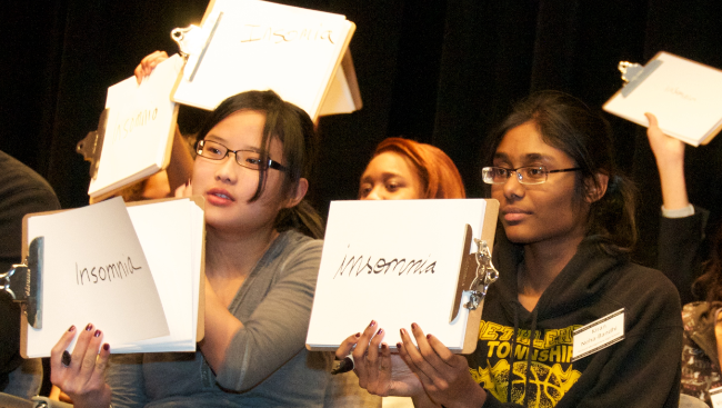 Students hold up answers 